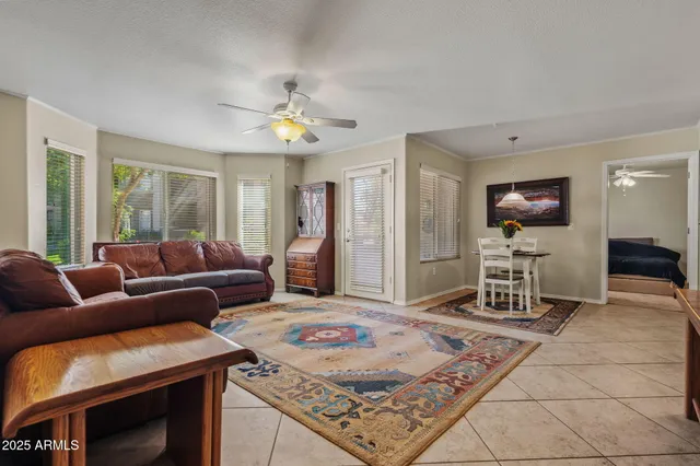 a living room with furniture a flat screen tv and a table