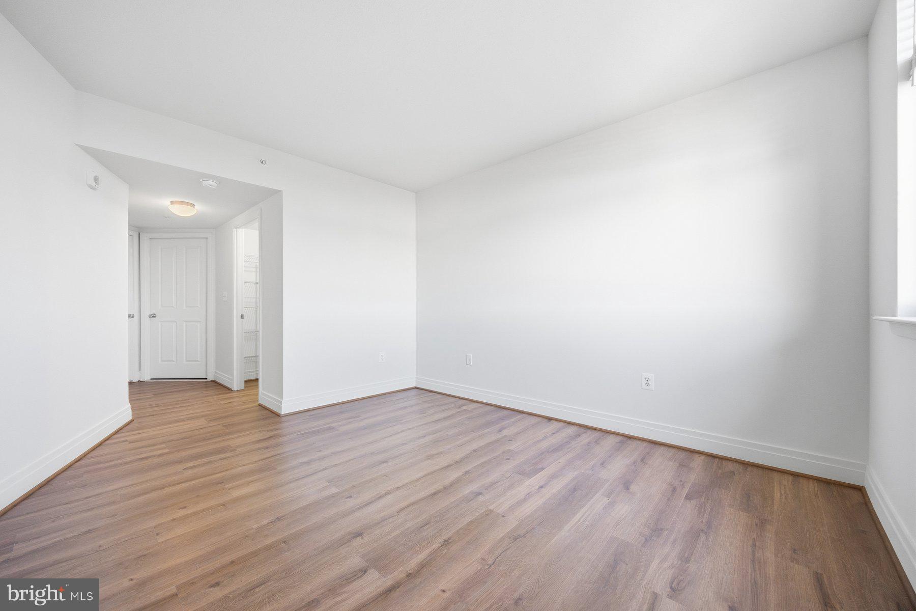 414 Water Street, Unit 2309 Baltimore, MD 21202 - Photo 11 of 36 a view of an empty room with wooden floor