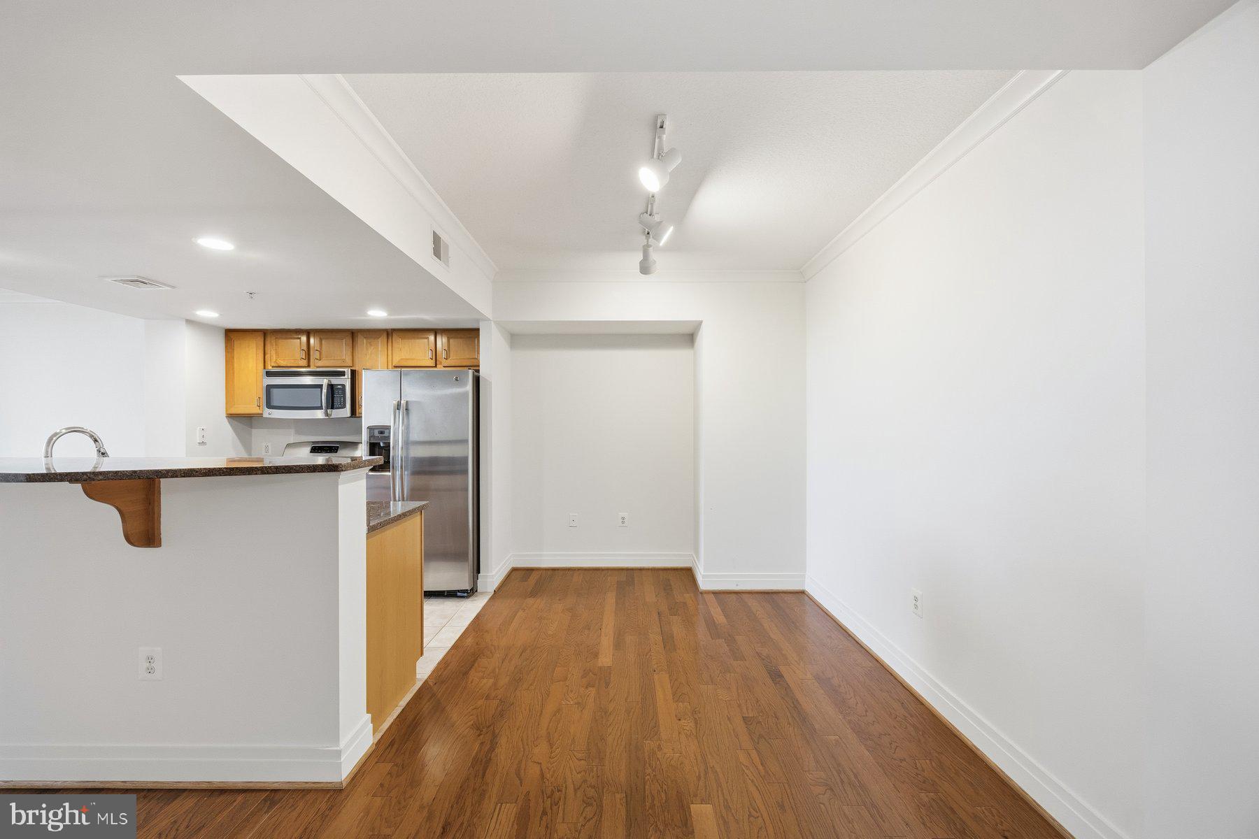 414 Water Street, Unit 2309 Baltimore, MD 21202 - Photo 12 of 36 a view of a kitchen with wooden floor