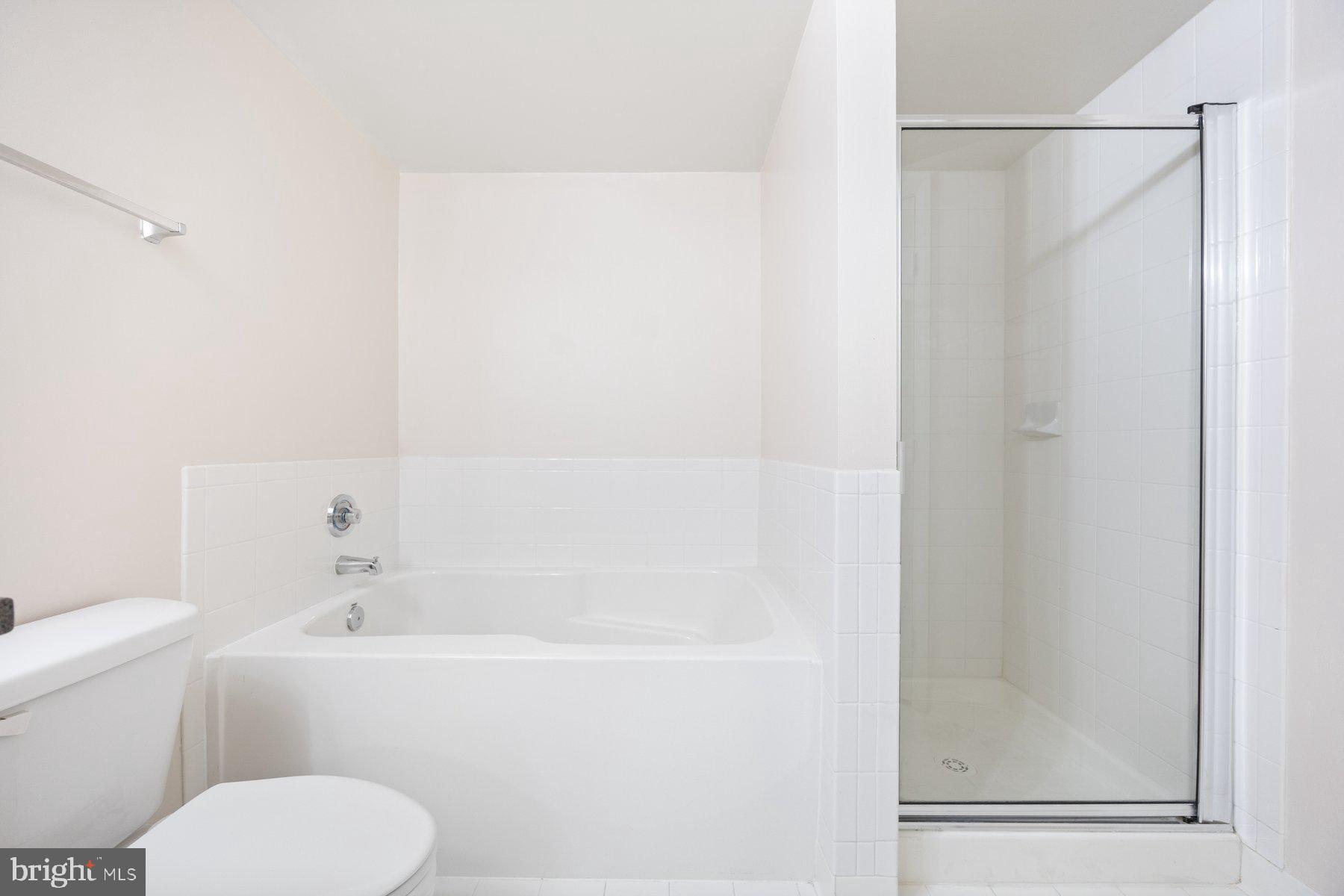 414 Water Street, Unit 2309 Baltimore, MD 21202 - Photo 14 of 36 a bathroom with a shower and a toilet