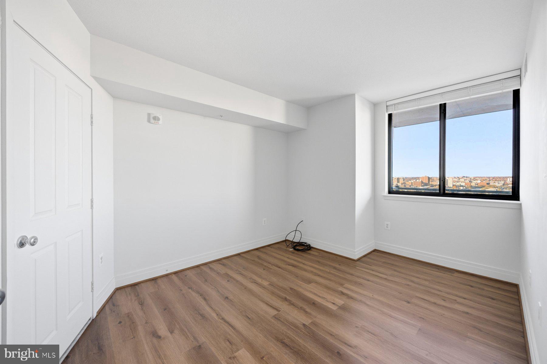 414 Water Street, Unit 2309 Baltimore, MD 21202 - Photo 19 of 36 a view of empty room with wooden floor and fan