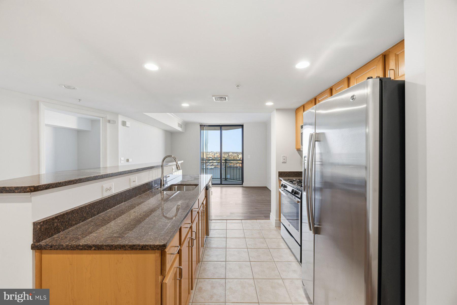 414 Water Street, Unit 2309 Baltimore, MD 21202 - Photo 2 of 36 a kitchen with stainless steel appliances granite countertop a refrigerator and a sink
