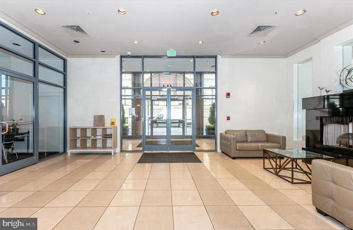 414 Water Street, Unit 2309 Baltimore, MD 21202 - Photo 30 of 36 a living room with furniture and a flat screen tv