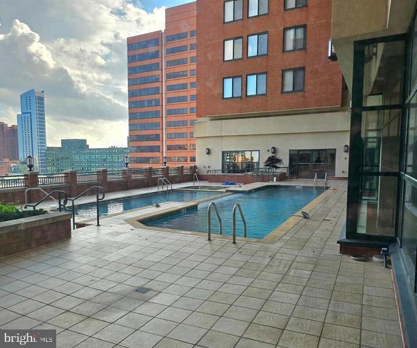 414 Water Street, Unit 2309 Baltimore, MD 21202 - Photo 32 of 36 a view of a swimming pool with a lounge chair