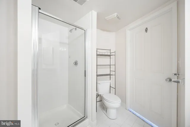 a bathroom with a toilet and shower