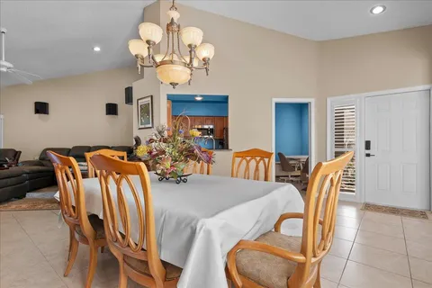 a view of a dining room with furniture and chandelier