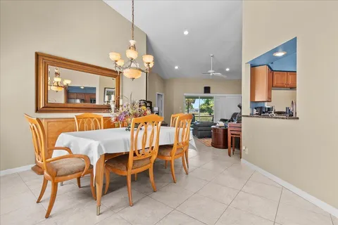 a view of a dining room with furniture and a chandelier