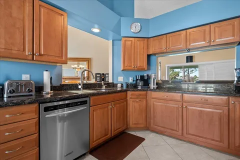 a kitchen with stainless steel appliances granite countertop a stove sink and cabinets
