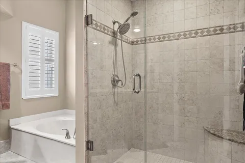 a bathroom with a shower and a window