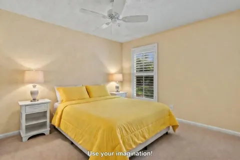 a bed sitting in a bedroom next to a lamp