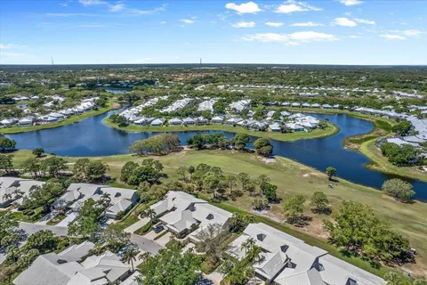 an aerial view of residential building and lake