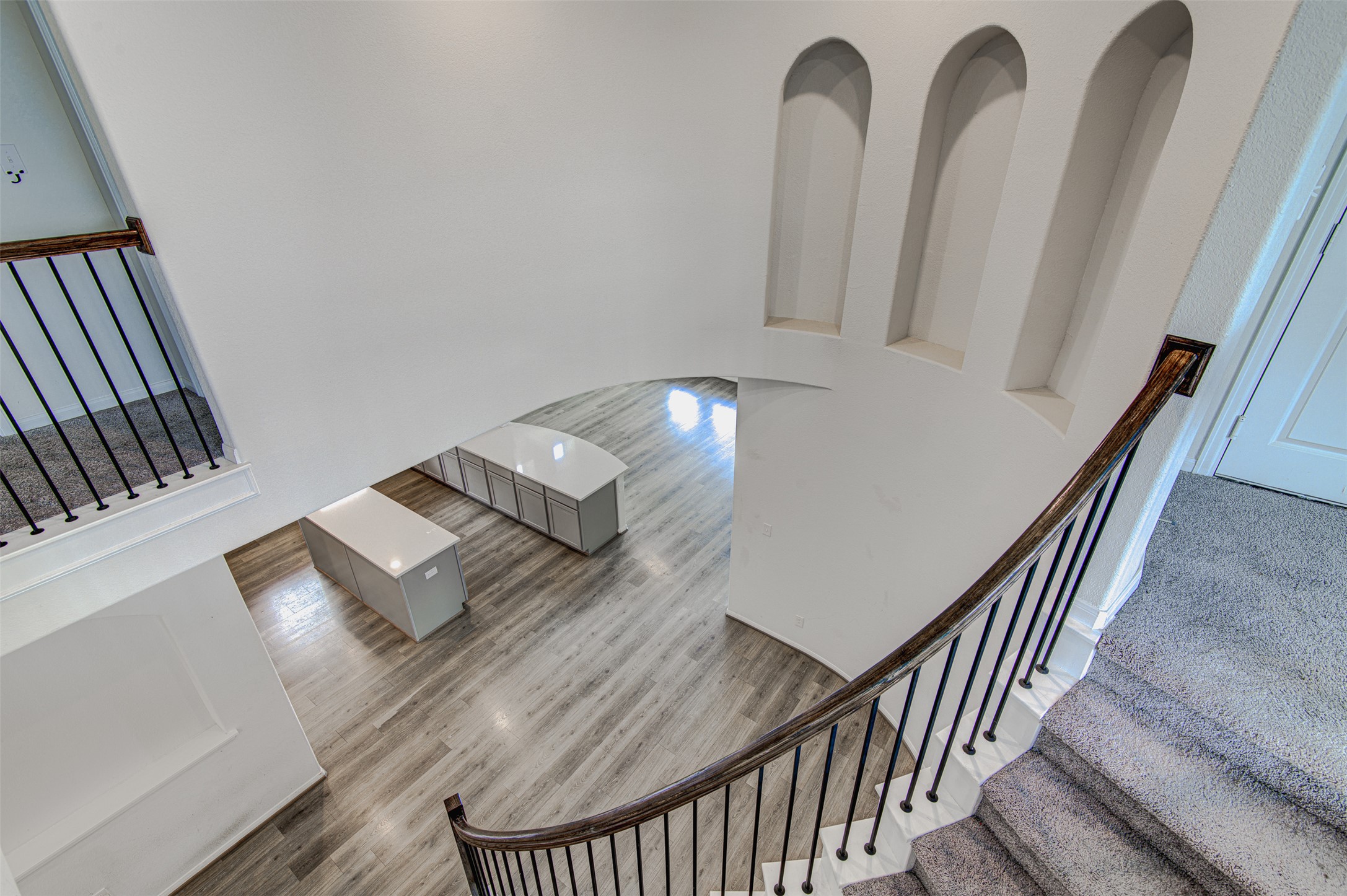 774 Cherrystone Loop Buda, TX 78610 - Photo 31 of 38 Flowing architectural elements and a grand curved staircase define this open-concept interior.