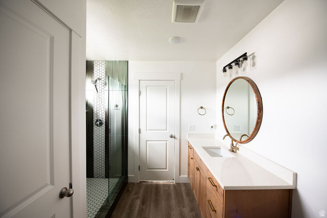 384 Ropelato Drive Nibley, UT 84321 - Photo 13 of 25 Bathroom featuring vanity, a shower stall, and dark wood finished floors