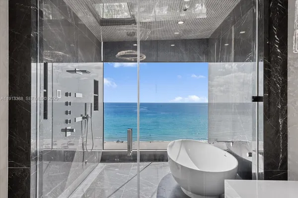 a bathroom with a tub and shower