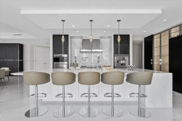 a large kitchen with granite countertop a table and chairs