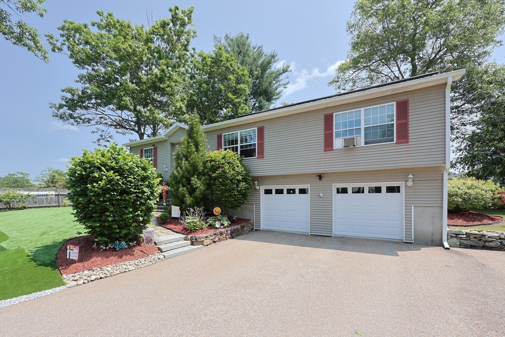 4 Colonial Road Webster, MA 01570 - Photo 1 of 38 a front view of a house with a yard and garage