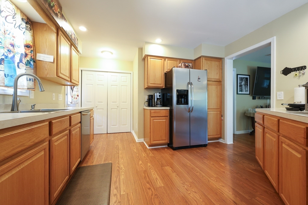 4 Colonial Road Webster, MA 01570 - Photo 13 of 38 a kitchen with stainless steel appliances a refrigerator and wooden cabinets