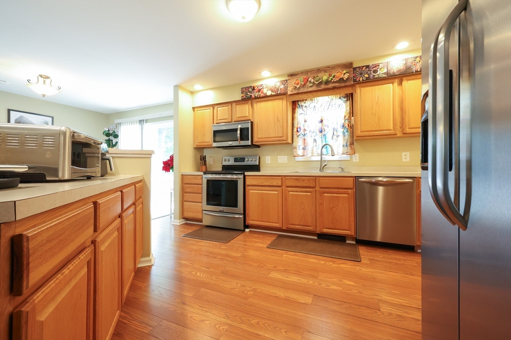 4 Colonial Road Webster, MA 01570 - Photo 14 of 38 a kitchen with stainless steel appliances a stove sink and refrigerator