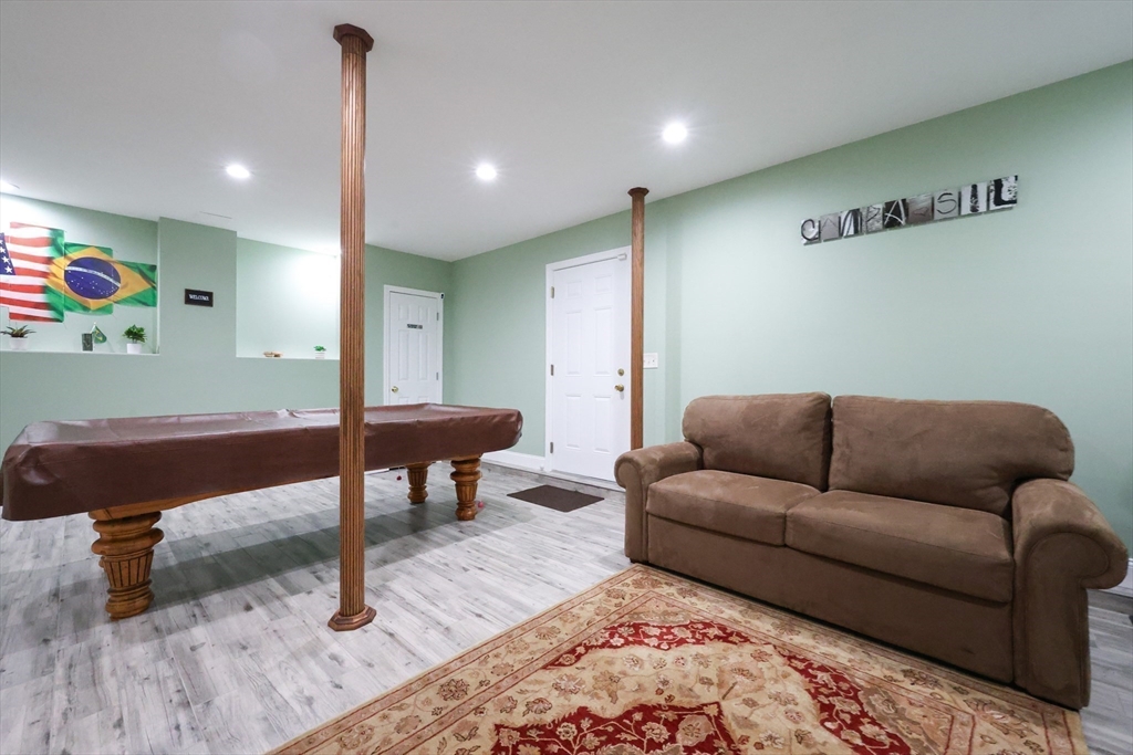 4 Colonial Road Webster, MA 01570 - Photo 31 of 38 a living room with furniture and a wooden floor