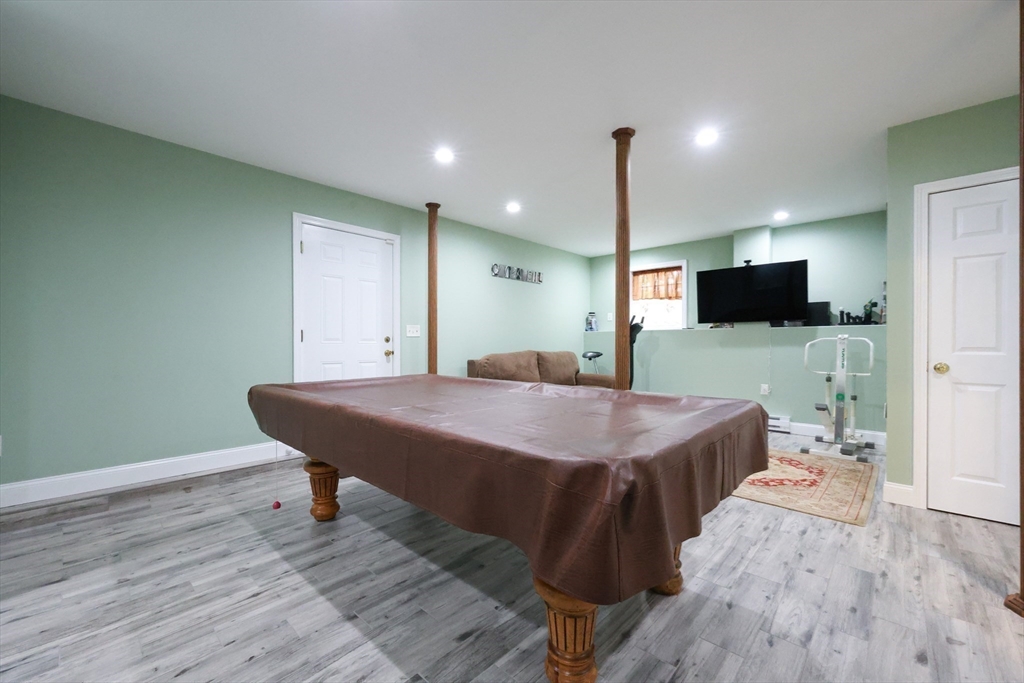 4 Colonial Road Webster, MA 01570 - Photo 32 of 38 a spacious bathroom with a granite countertop sink a mirror and a toilet