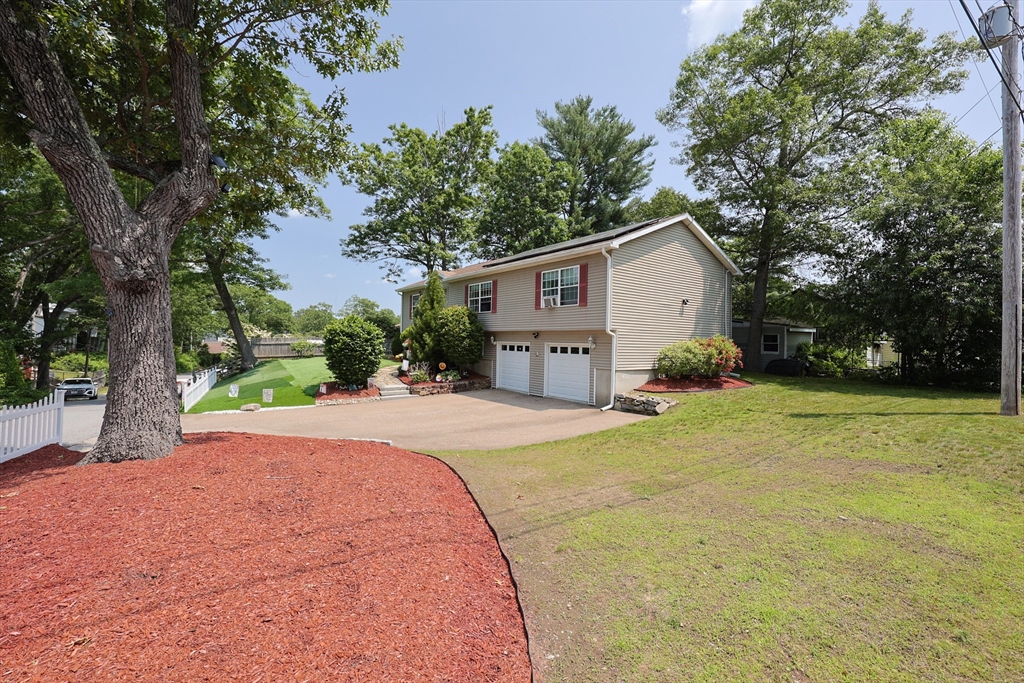 4 Colonial Road Webster, MA 01570 - Photo 36 of 38 a front view of a house with a yard and garage