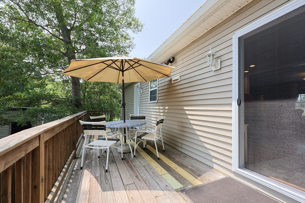 4 Colonial Road Webster, MA 01570 - Photo 38 of 38 a view of deck with furniture and barbeque oven in the backyard