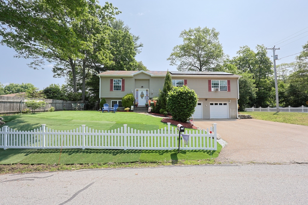 4 Colonial Road Webster, MA 01570 - Photo 4 of 38 a view of a house with a street and a garden