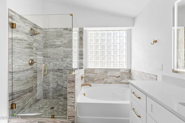 a bathroom with a bathtub and shower