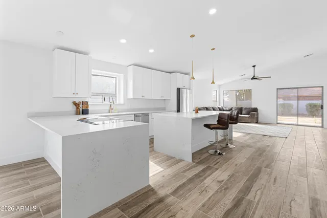 a living room with furniture a dining table and chairs