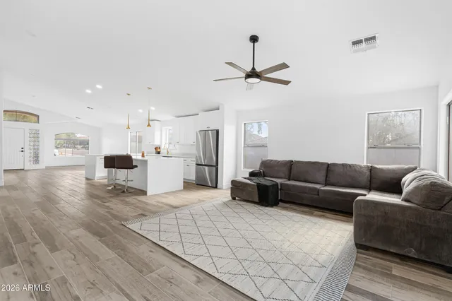 a living room with furniture and kitchen view