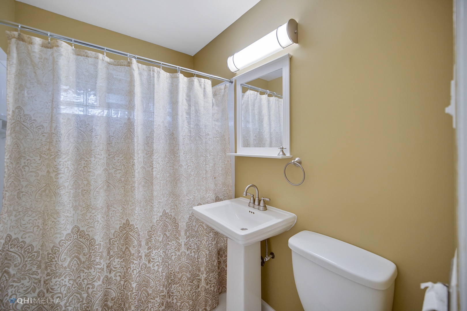 1217 183rd Street Homewood, IL 60430 - Photo 15 of 19 a bathroom with a sink a toilet and a mirror