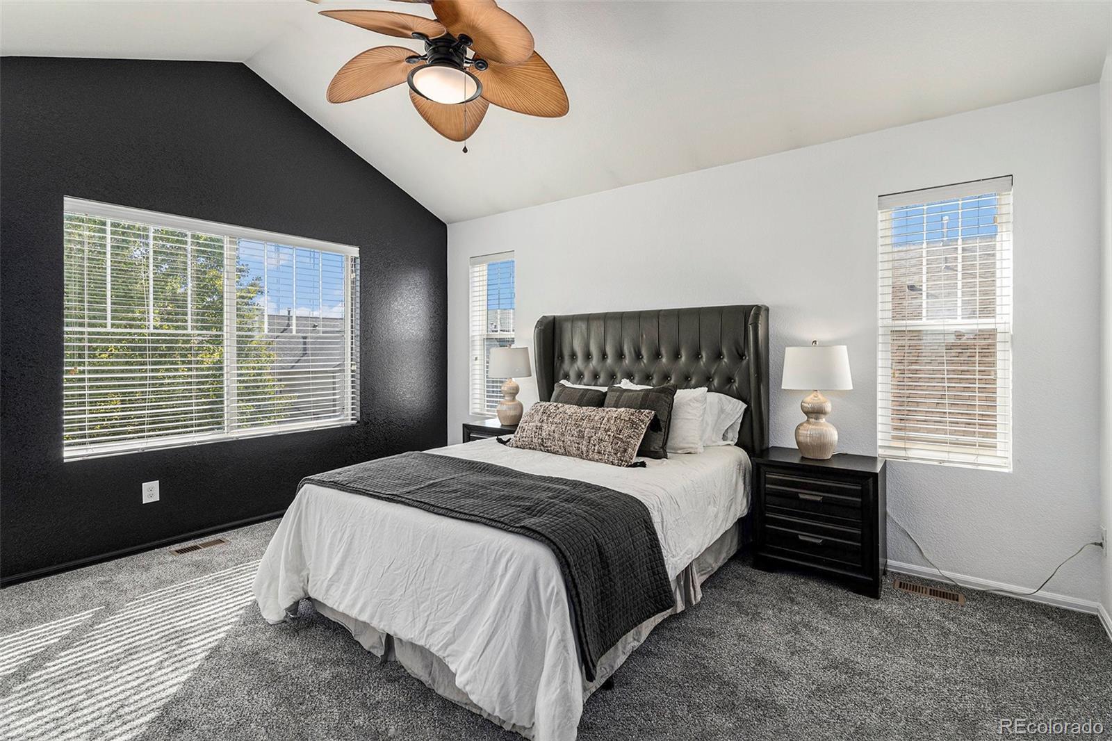 25970 East 3rd Avenue Aurora, CO 80018 - Photo 13 of 26 a bedroom with a bed lamp and a large window