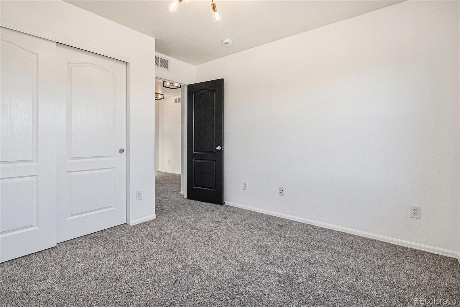 25970 East 3rd Avenue Aurora, CO 80018 - Photo 17 of 26 an empty room with closet area