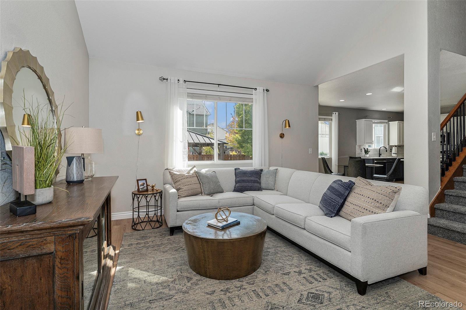 25970 East 3rd Avenue Aurora, CO 80018 - Photo 5 of 26 a living room with furniture and a flat screen tv