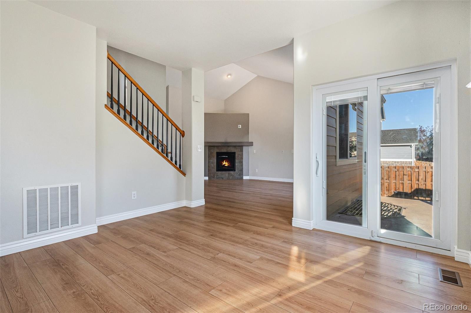 25970 East 3rd Avenue Aurora, CO 80018 - Photo 10 of 26 a view of a hallway with wooden floor and entryway