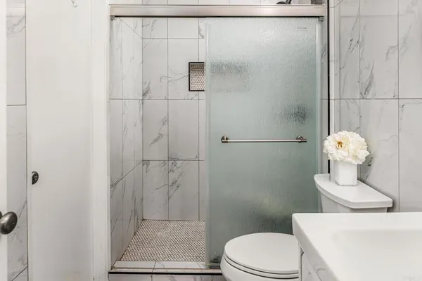 a white toilet sitting next to a bathroom sink