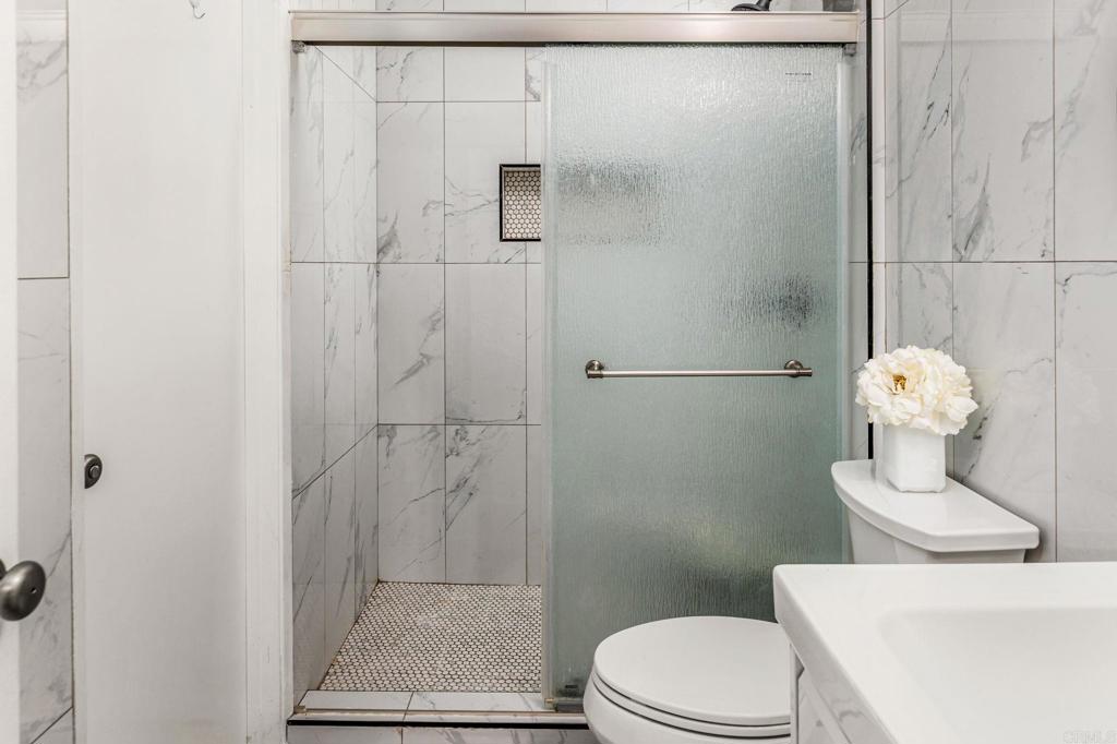 3446 Los Mochis Way Oceanside, CA 92056 - Photo 11 of 17 a white toilet sitting next to a bathroom sink