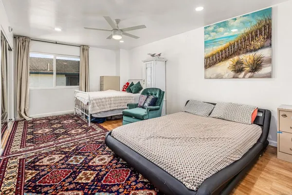 a bedroom with two beds and a large window