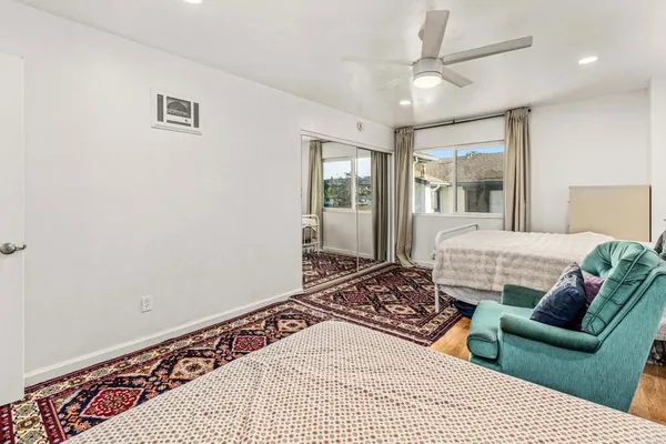 a bedroom with a large bed and a couch