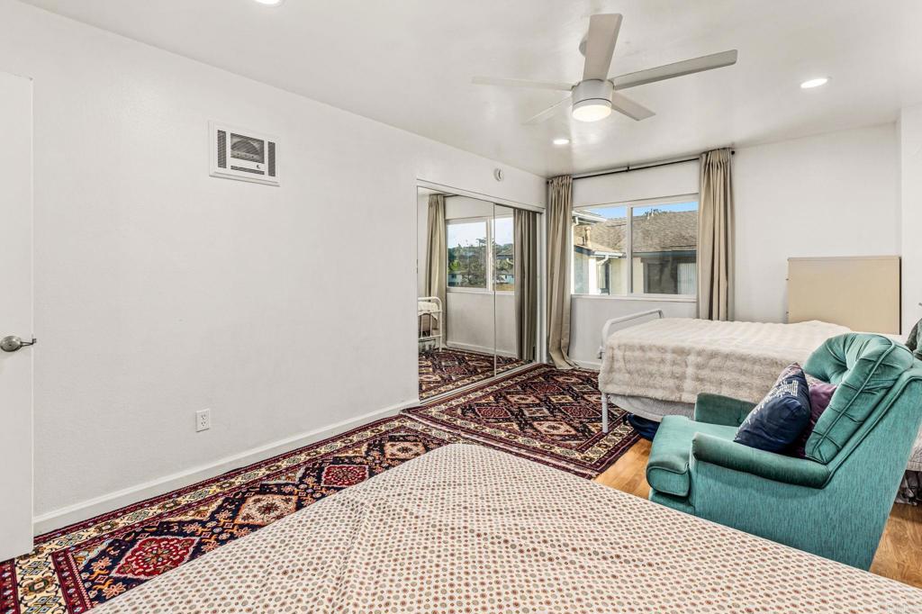 3446 Los Mochis Way Oceanside, CA 92056 - Photo 13 of 17 a bedroom with a large bed and a couch