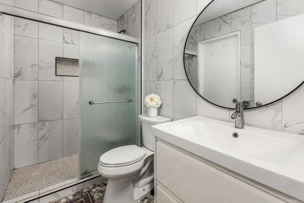 a bathroom with a sink toilet and shower