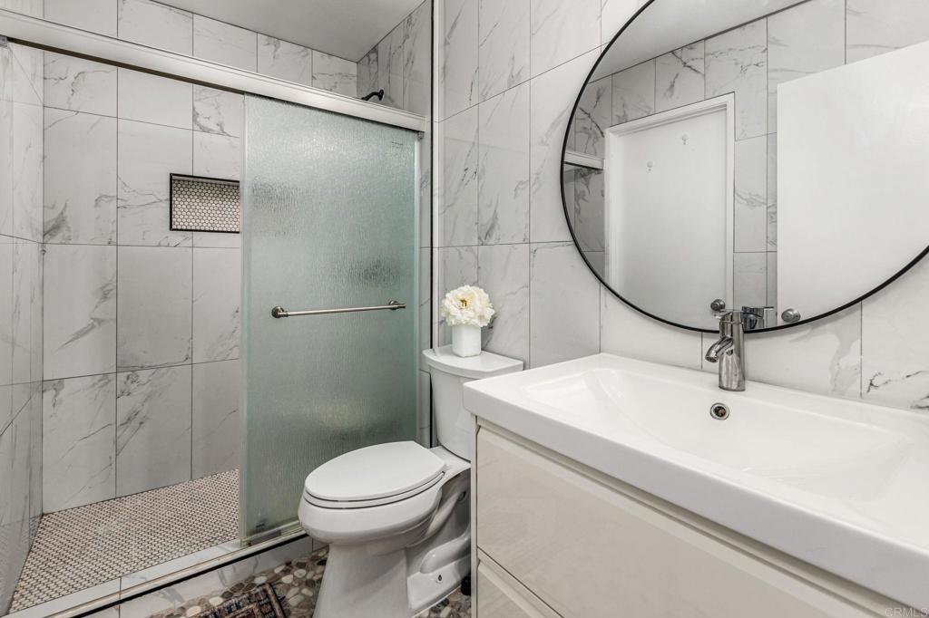 3446 Los Mochis Way Oceanside, CA 92056 - Photo 10 of 17 a bathroom with a sink toilet and shower