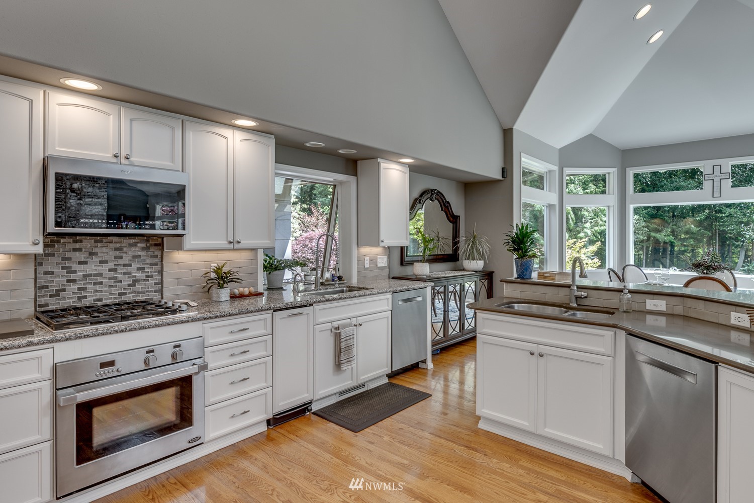 13819 3rd Drive Southeast Everett, WA 98208 - Photo 13 of 39 a kitchen with stainless steel appliances granite countertop white cabinets a sink a stove a microwave a counter space and cabinets