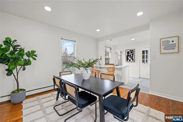 a view of a dining room with furniture and wooden floor