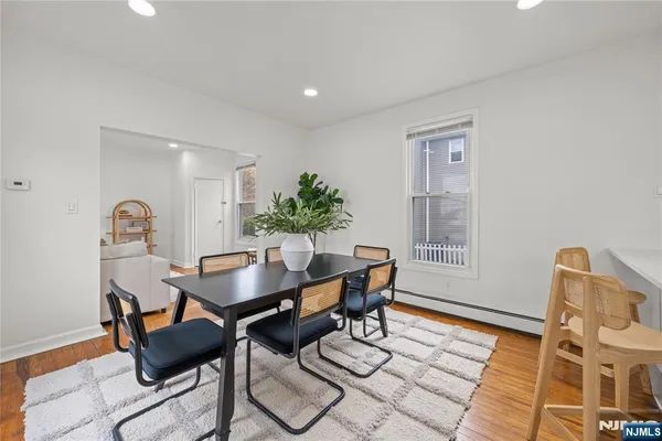 a view of a dining room with furniture and wooden floor