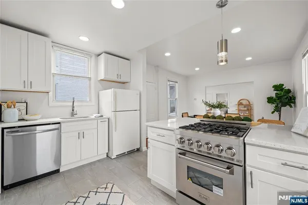 a stove top oven sitting inside of a kitchen