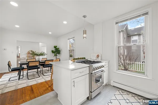 a kitchen with a stove and white cabinets