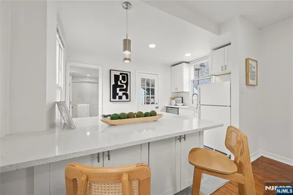 a kitchen with stainless steel appliances granite countertop a sink and a refrigerator