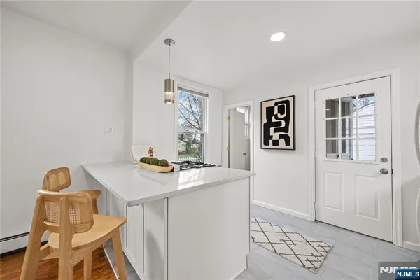 a view of a workspace with furniture and wooden floor