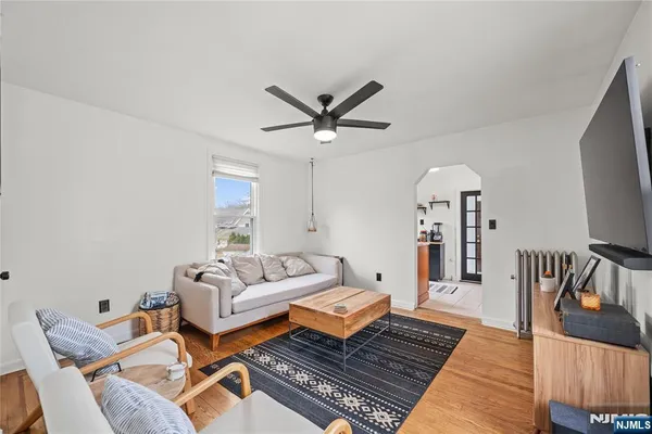 a living room with furniture a rug and a chandelier